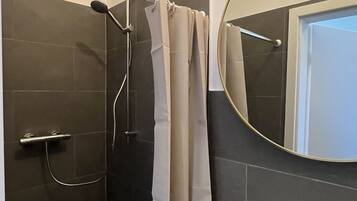 Shower, hair dryer, towels, toilet paper