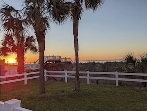Enjoy a serene beachfront setting with a wooden bridge leading to the shore.