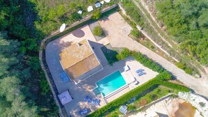 An aerial view of a property with a swimming pool, outdoor seating, and a covered patio area. - Villa Anamari in (Corfu)