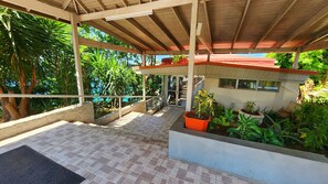 Step into a serene oasis surrounded by lush greenery, featuring a staircase and a charming small building.