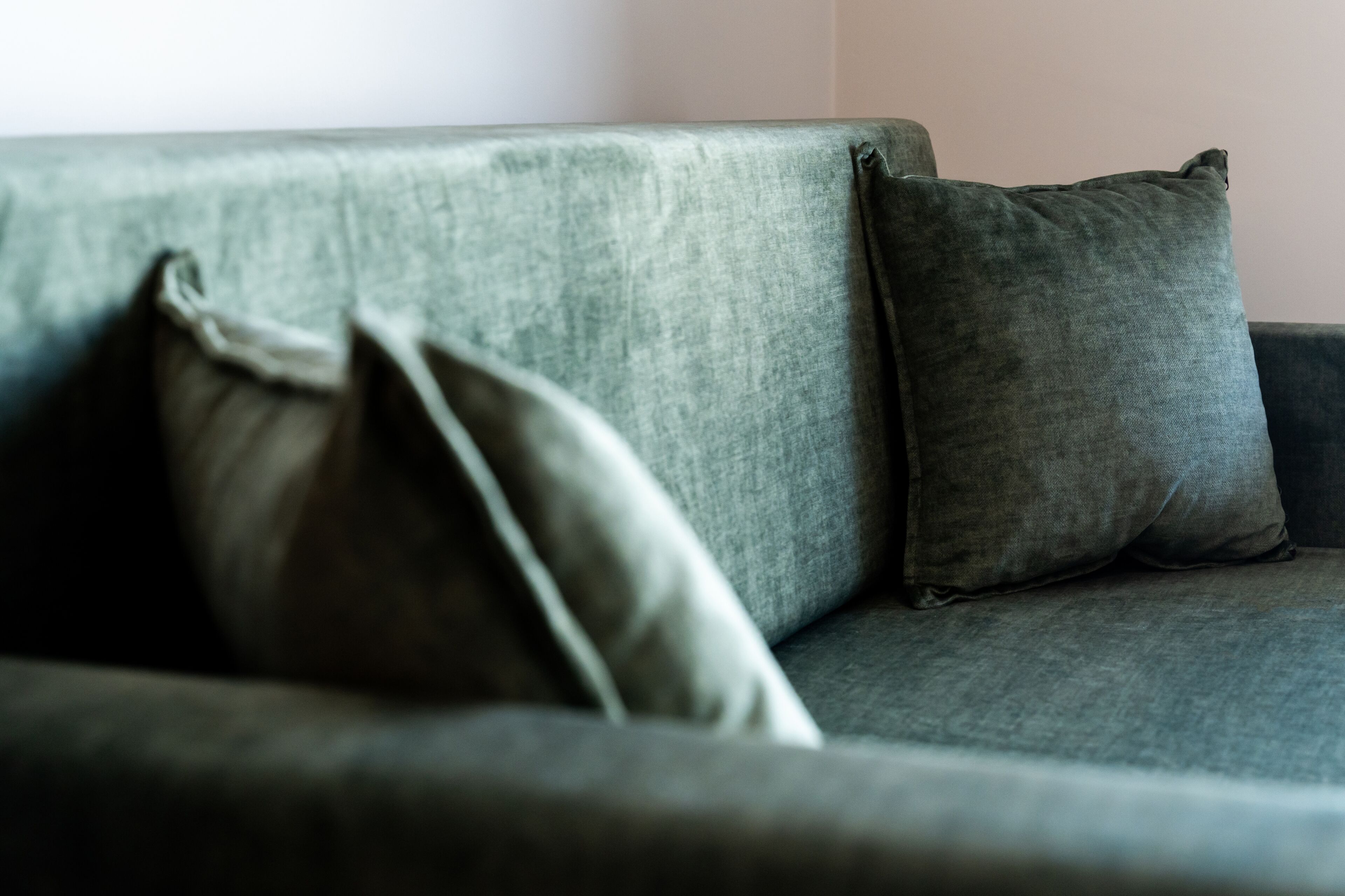 A grey sofa with two cushions.