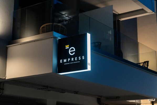 A sign for 'Empress Luxury Residences' with a crown symbol, indicating a high-end property. - Empress Luxury Residences (Volos)