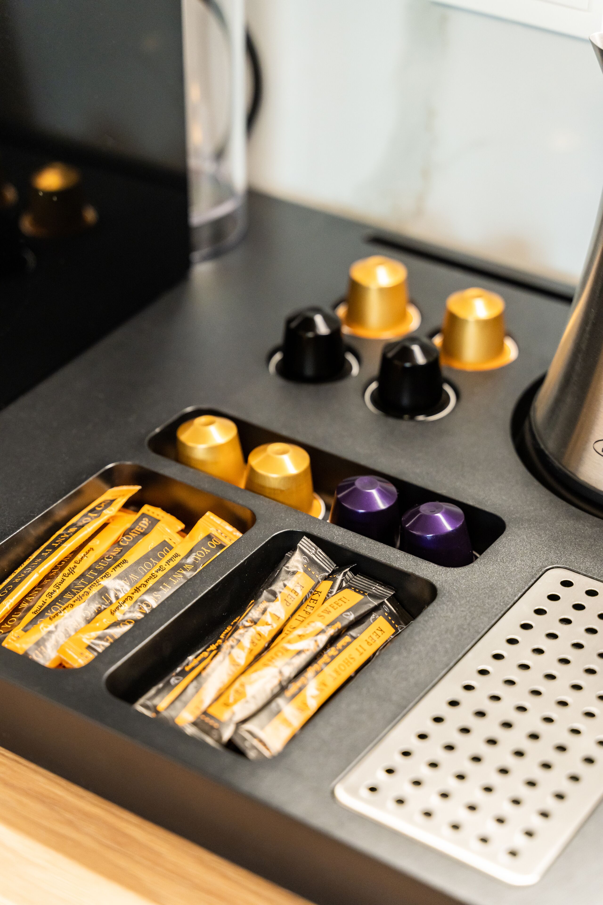A kitchen counter with various kitchen tools and utensils, including knives and measuring cups.