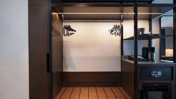 A compact, modern kitchenette with a built-in coffee maker, a microwave, and a small refrigerator.