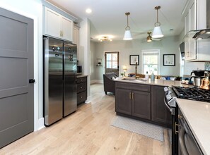 Enjoy meal preparation in this well-lit kitchen with a spacious island and ample counter space.