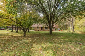 A stone house with a lawn and trees. - Kona's Cozy Cabin — King Bed, Fireplace, Pet Friendly, Near Hiking and Wineries (Winchester)