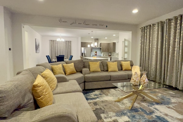 Living room with sectional and coffee table, smart tv