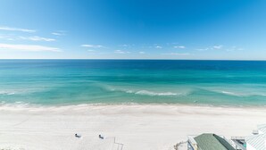 A beach with a clear sky and calm sea.