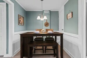 Enjoy meals in this cozy dining area with a table for two and a bench.