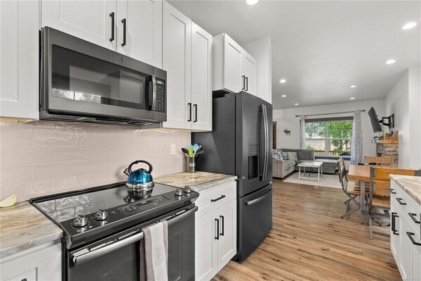 Enjoy cooking in this well-equipped kitchen with a gas stove, oven, and microwave.