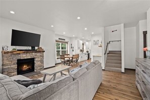 Cozy living space with a fireplace, flat-screen TV, and comfortable seating area.