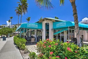A Caribbean Fish Market with outdoor seating and a pathway.