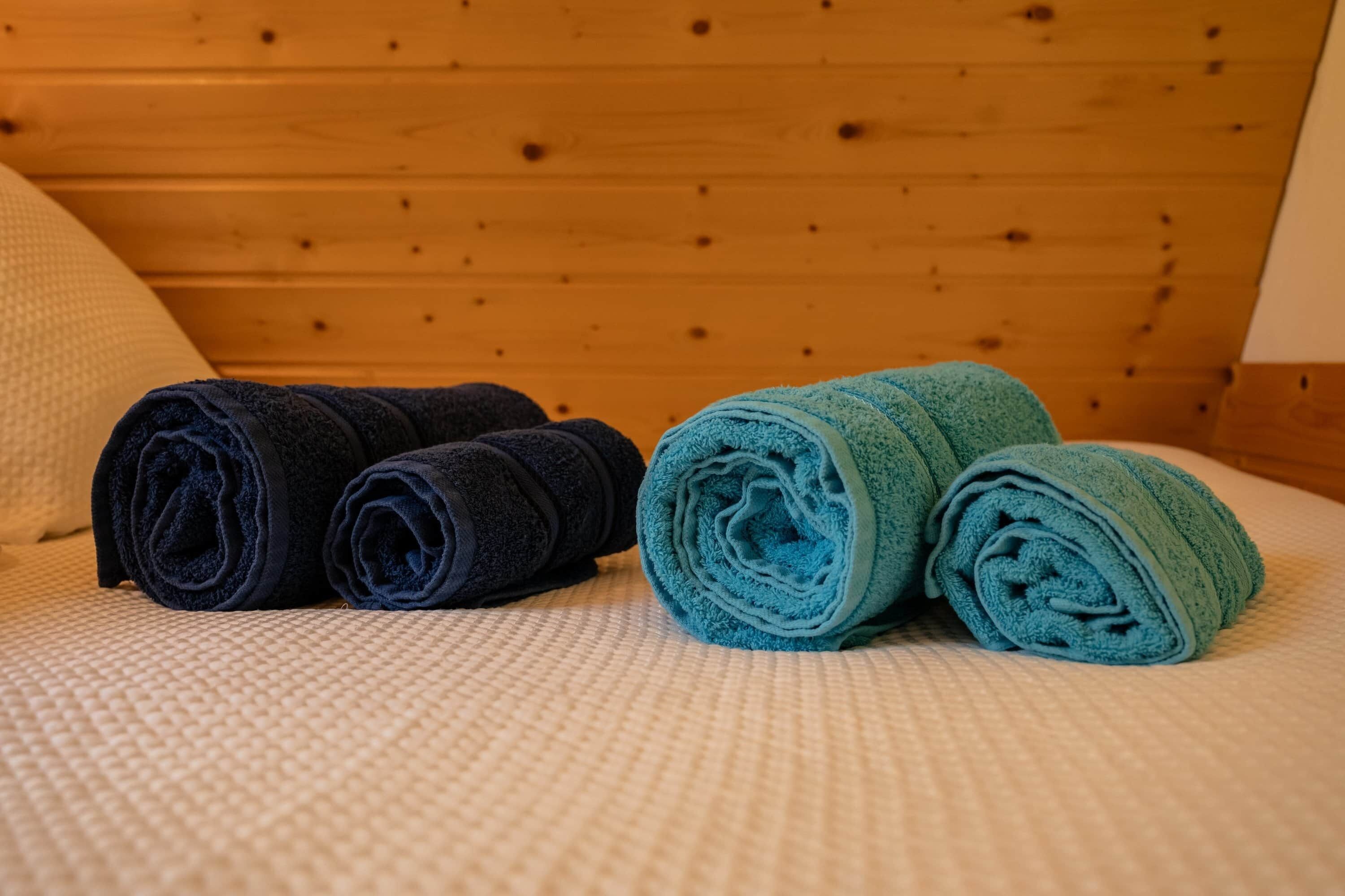 Una cama con cubreblanco texturizado y cabecera de madera.