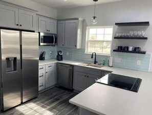 Enjoy cooking in this well-equipped kitchen with a refrigerator, microwave, and dishwasher.