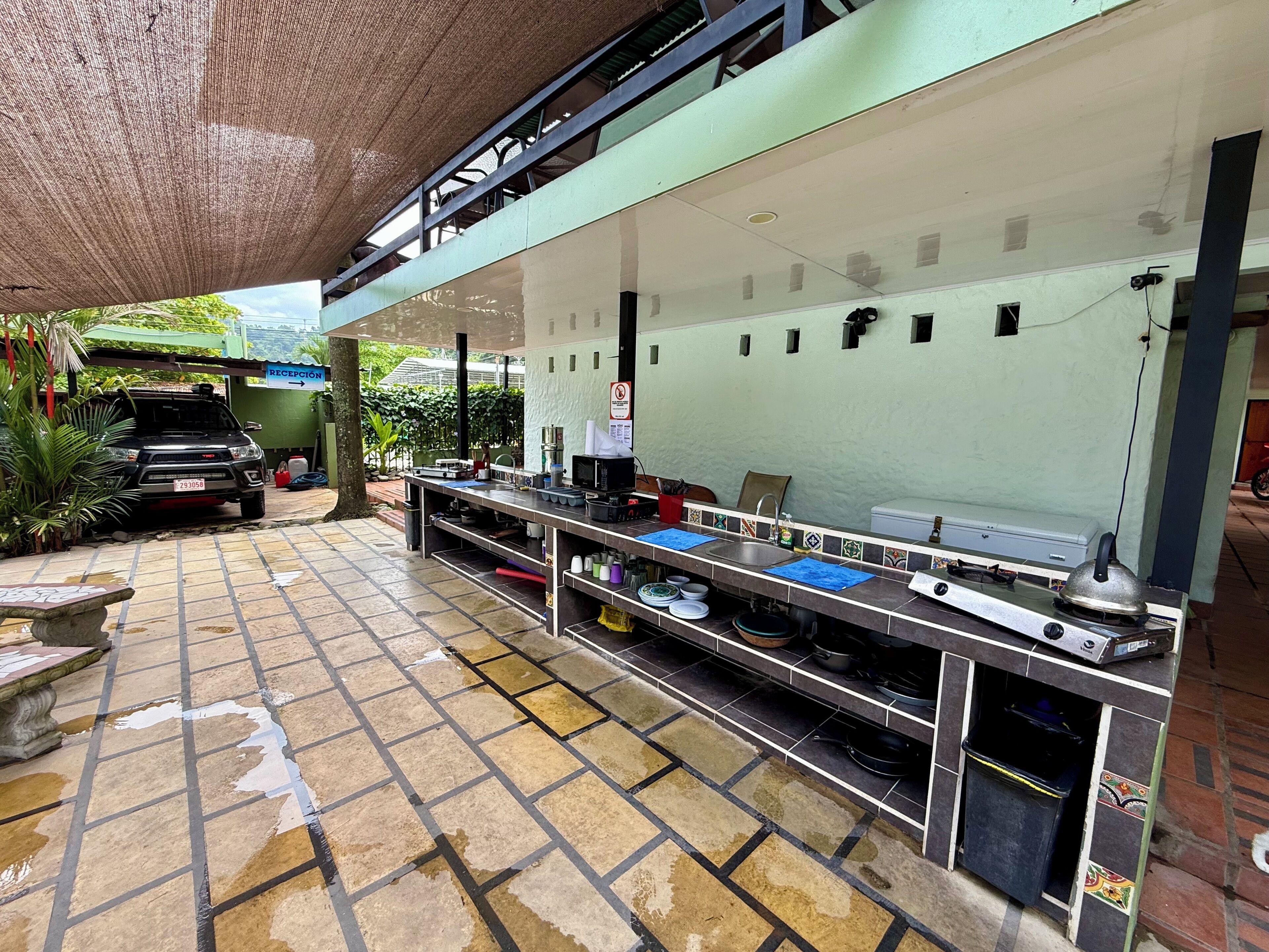 A kitchen area with a tiled backsplash, stainless steel countertops, and a gas stove.