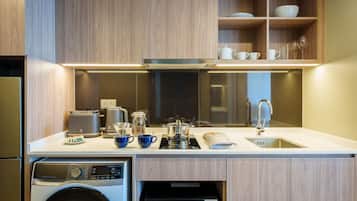 A modern kitchen with wooden cabinets, a built-in oven, a dishwasher, and a sink.