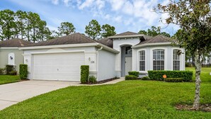 A single-story house with a garage, a front porch, and a well-maintained lawn.
