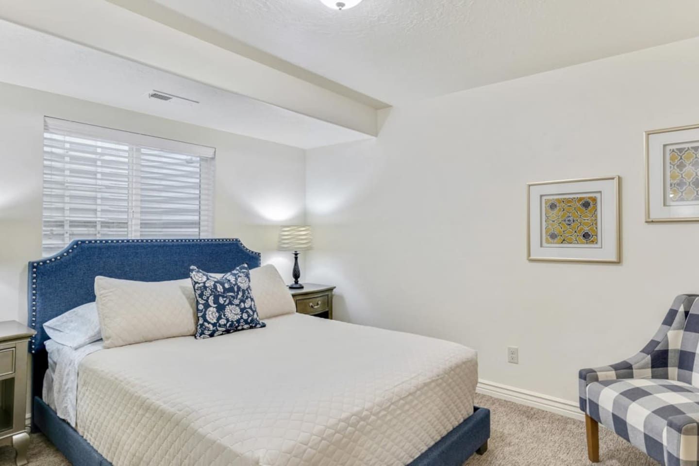 Queen bedroom with a navy tufted headboard