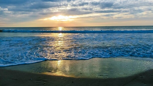 A beach with waves and a sunset. - Seaglass Shores, Steps to the Beach (Cape Canaveral)