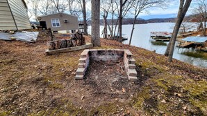 A lakeside cabin with a fire pit and dock. - Lake of the Ozarks Secluded Vacation Home Waterfront with a Covered Dock. (Stover)