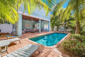 A heated pool, sun loungers