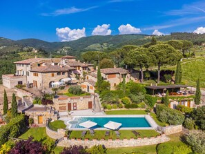 Relax by the pool surrounded by lush greenery and rolling hills.