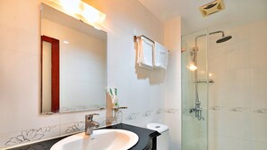 A bathroom with a sink, mirror, toilet, and shower. - S79 Boutique Hotel by hostify (Ho Chi Minh City)