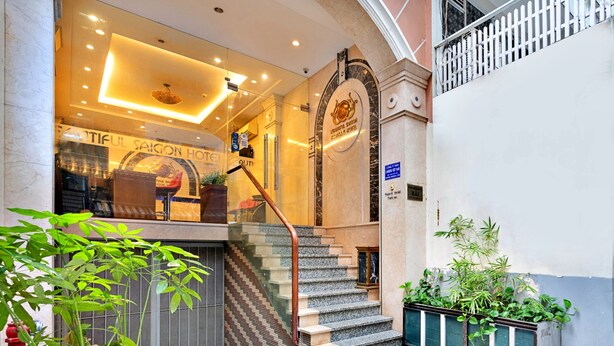 A hotel entrance with a staircase leading to the lobby, a glass door, and a sign indicating the hotel name. - S79 Boutique Hotel by hostify (Ho Chi Minh City)