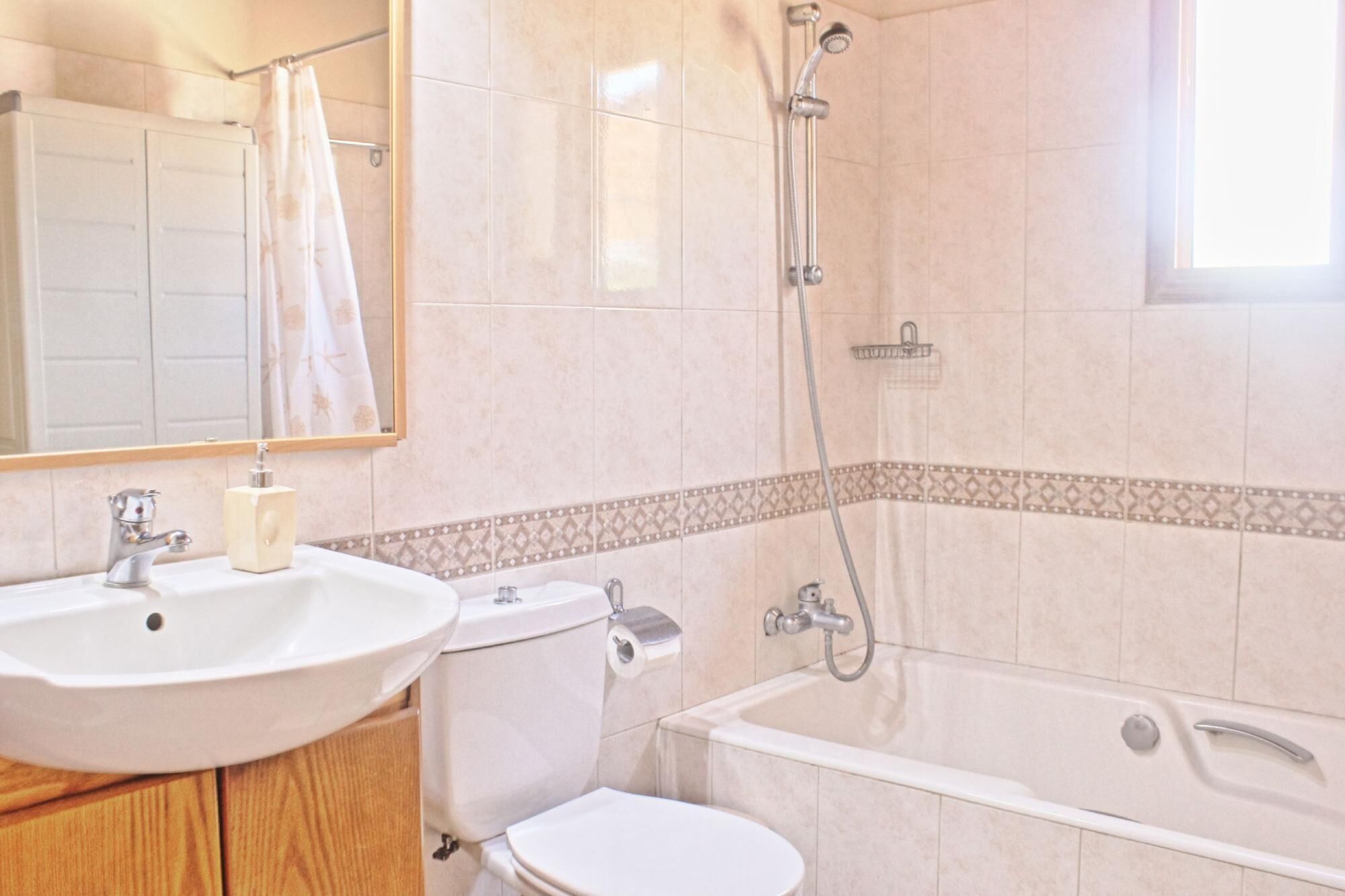 A bathroom with a sink, toilet, and bathtub.
