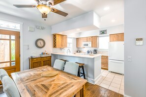 Enjoy cooking in this well-lit kitchen with a central island and bar stools.