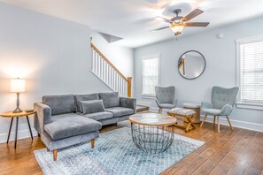 Relax in this inviting living space with a comfortable sofa, coffee table, and area rug.