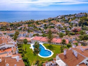 Enjoy a leisurely atmosphere surrounded by well-maintained lawns and palm trees, with a central pool and Mediterranean-style homes.