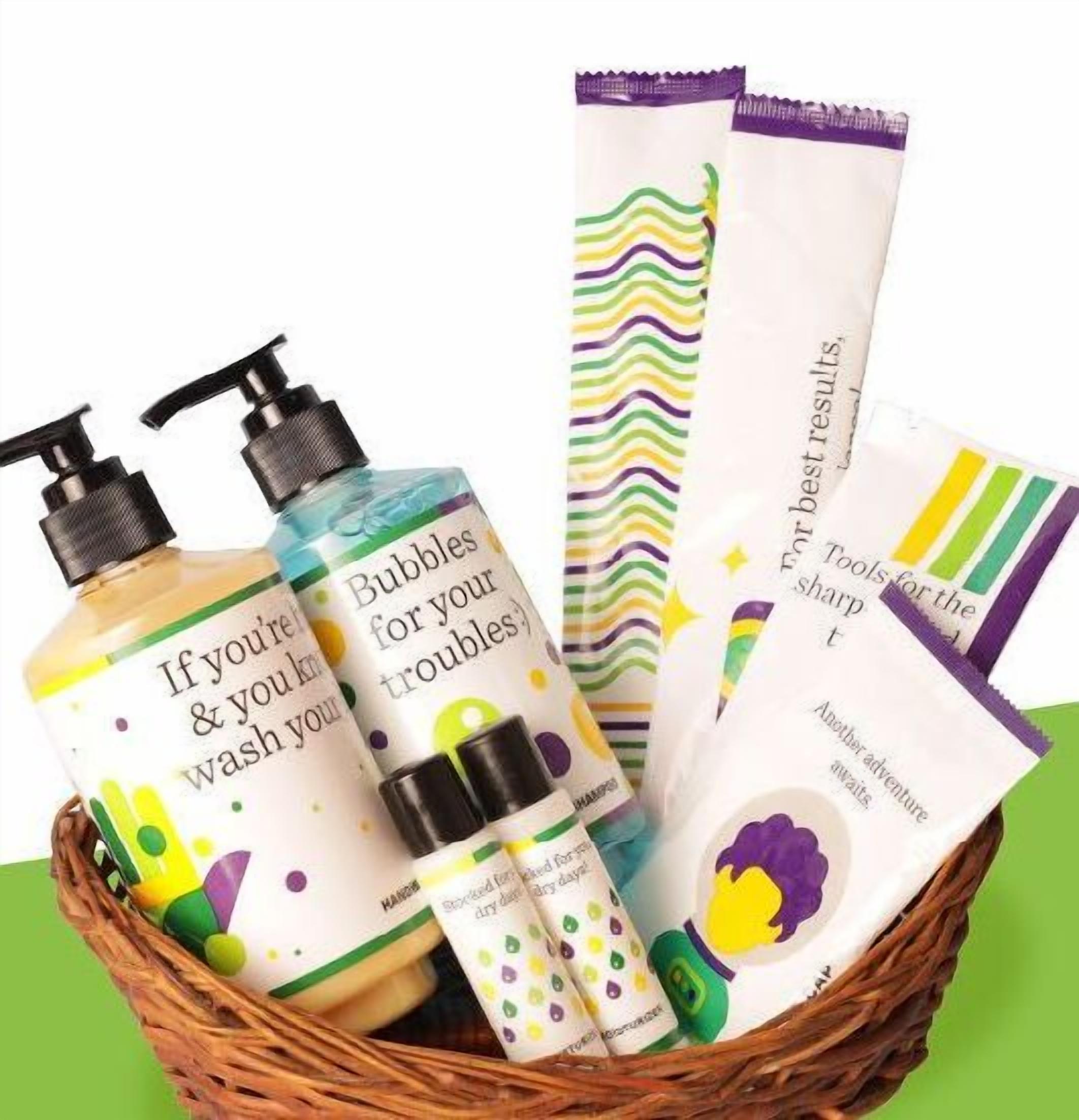 A basket containing various personal care products, including bottles and tubes with colorful labels.