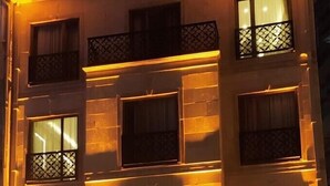 A multi-story hotel with illuminated windows and a visible entrance. - Zem Hotel (Istanbul)