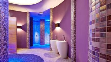Bathroom features a unique mosaic tile design, two large sinks, and recessed lighting.