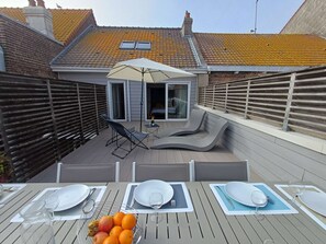 A rooftop patio with a dining setup, including tables, chairs, and a fruit bowl. - Albion House : central, spacious & comfort (Le Touquet)