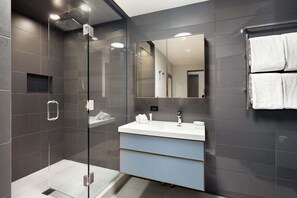 A modern bathroom with a glass-enclosed shower, a white sink, and a large mirror. - Alpenblick 10 | Three level Townhome, Two Block From the Gondola (Aspen)