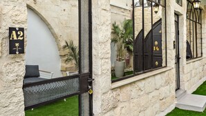 A stone building with a black door and a sign reading "A2".