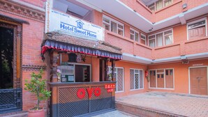 A hotel entrance with a sign reading "Hotel Sweet Home" and a "Restaurant" sign on the right. - Sweet Home Hotel (Bhaktapur)