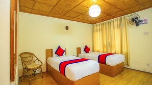A hotel room with two wooden beds, a wicker chair, a ceiling fan, and a woven ceiling. - Sweet Home Hotel (Bhaktapur)