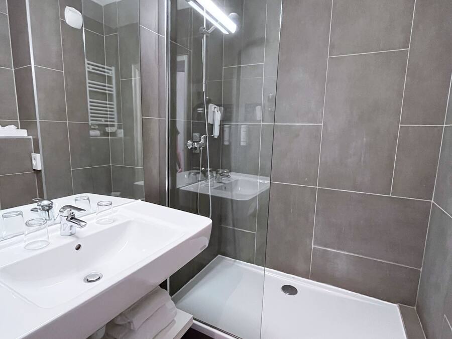 Separate bathtub and shower, towels
