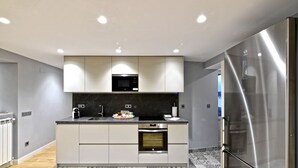 A modern kitchen with a built-in microwave, oven, and refrigerator.