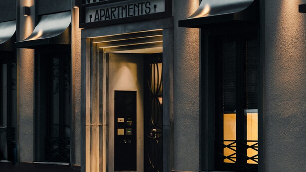 A building with a geometric facade and illuminated signage for 'WELTWIEN APARTMENTS'. - WELTWIEN Apartments (Vienna)