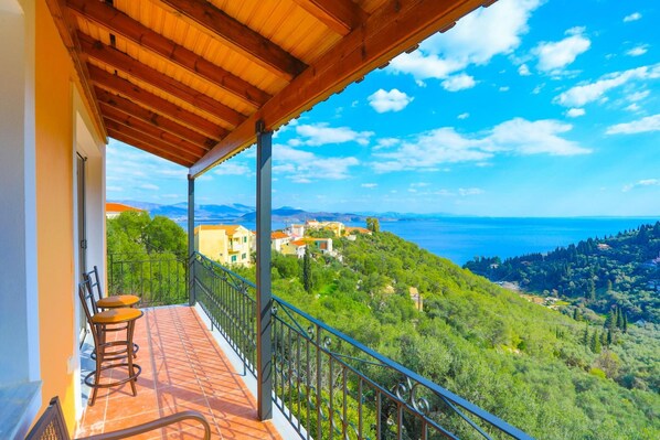 Enjoy breathtaking views of the sea and surrounding hills from this balcony.