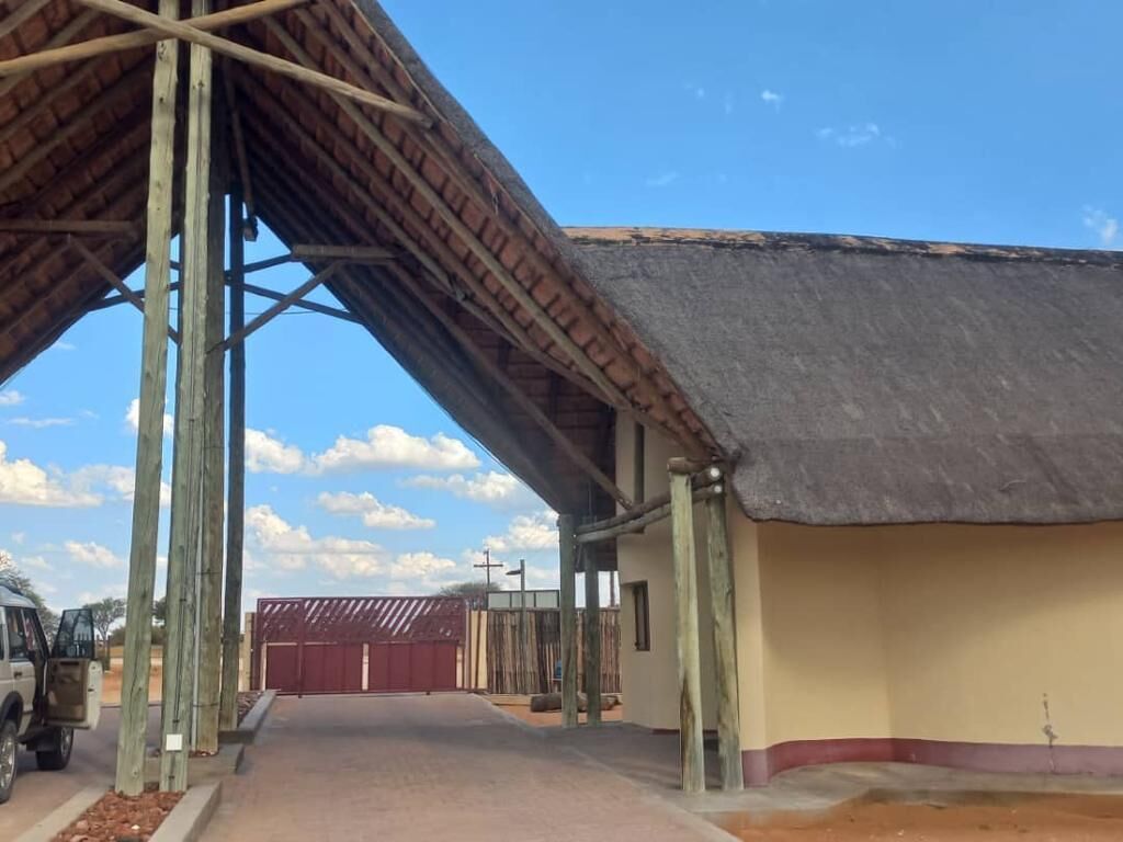 A building with a thatched roof and a covered walkway.