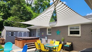 A backyard with a barbecue area, outdoor seating, and a hot tub. - Ivywood Escape Relaxing Stay (30+ Day Rental) (Nashville)