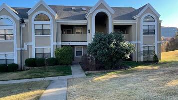 A two-story house with a front entrance, a covered porch, and a well-maintained lawn.