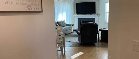 A living room with a fireplace, a television, and a sofa.
