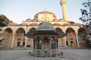 A historical building with a central dome, arched windows, and a tall minaret. - Nuray Hotel (Istanbul)