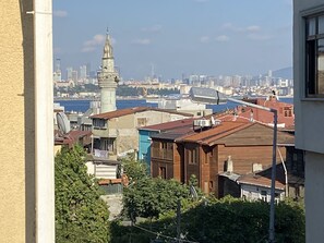 A cityscape with a prominent tower and a body of water in the background. - Nuray Hotel (Istanbul)